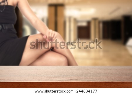 dark brown desk and legs of woman