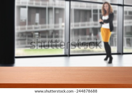 interior of office with window and modern landscape of city and red desk