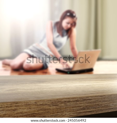 girl with laptop on the floor and interior of home with window and desk top