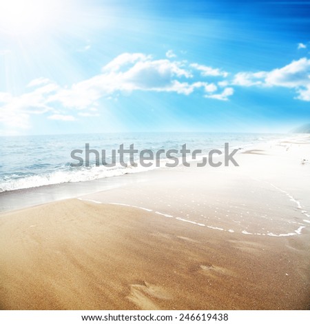 landscape of ocean and sun on sky with big wave on sand