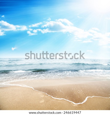 landscape of ocean and sun on sky with waves