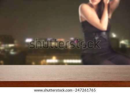 desk of brown and woman in black and city