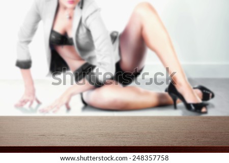 background with woman in background on the floor and dark brown desk space