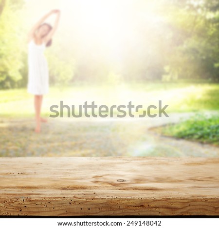 desk of wood green garden and woman in white dress