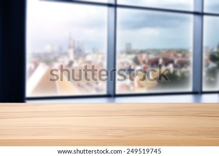 yellow desk space and window of blue color and city space