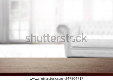interior of big window and white couch and dark brown desk space