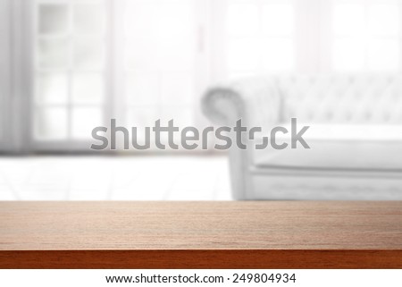 interior of big window and white couch and brown board