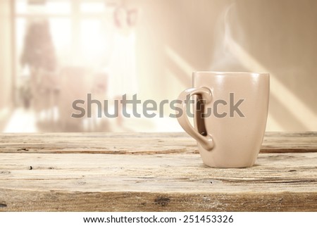 morning sun in window and mug of coffee and desk of wood
