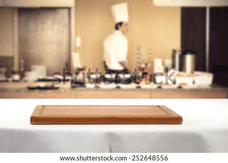 white table with brown desk of wood and cook man
