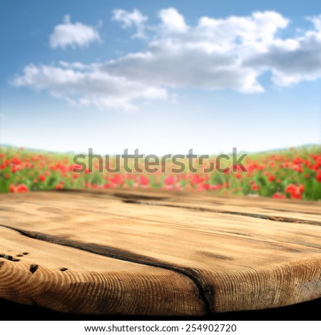 worn old table sky of blue and red flowers