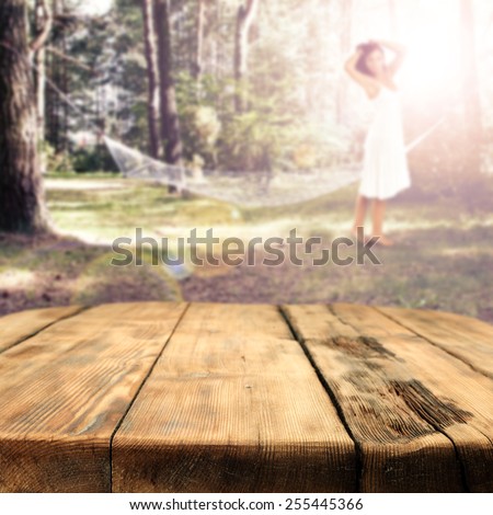 young woman in white dress and big table of wood