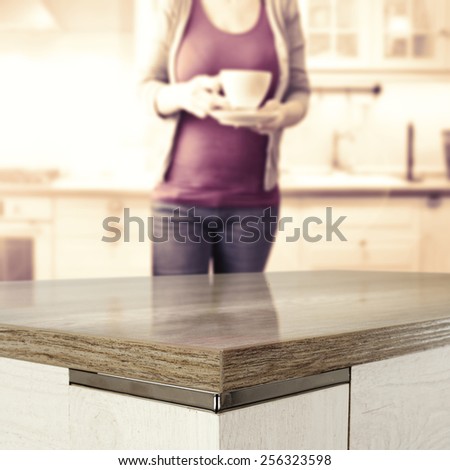 background of table in  kitchen and woman with cup of tea