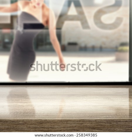 window of storefront and woman in black glass