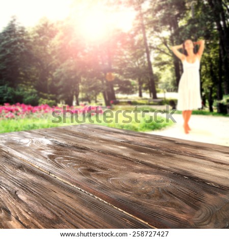 woman in white dress and big worn table of dark wood