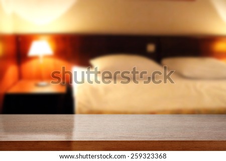 blur background of hotel room and brown desk