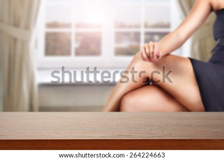 woman legs and dark brown desk of furniture