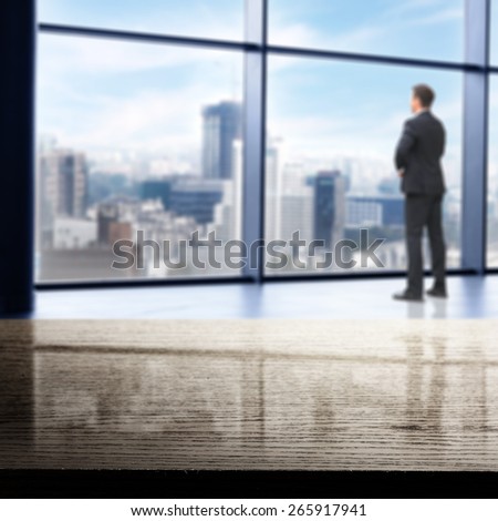office interior with big window and city landscape and dark black desk top and men in suit