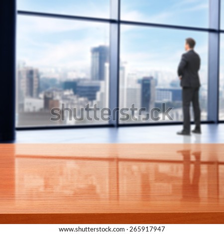office interior with big window and city landscape and red desk space and men in suit