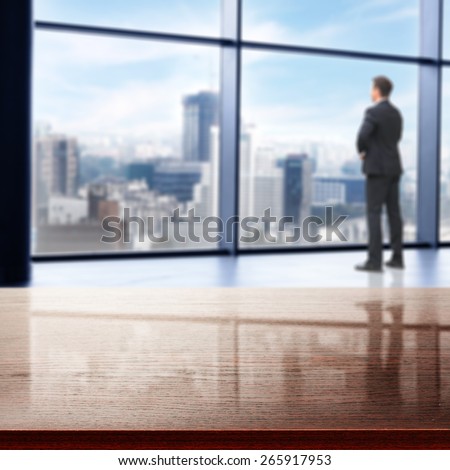 office interior with big window and city landscape and boss in suit and desk of dark color