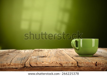 shadow of window on the wall and table with mug