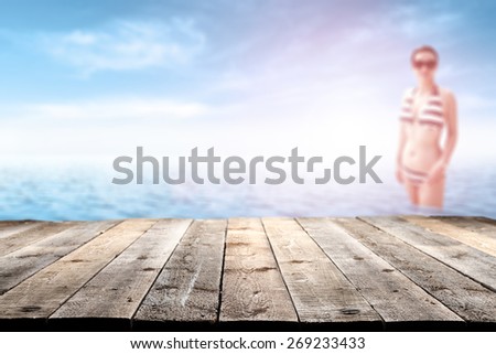 wooden old pier and woman in bikini suit