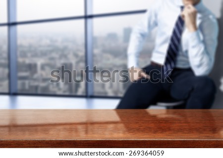 interior of office with big window and town landscape and brown desk space