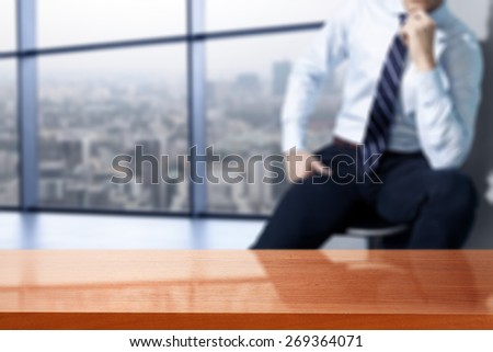 interior of office with big window and town landscape and red desk top