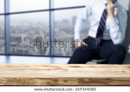 interior of office with big window and town landscape and wooden desk