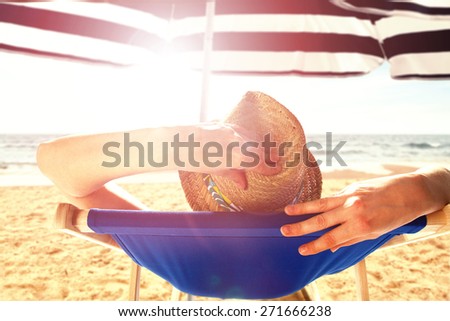 sunny day with woman on chair and hat with umbrella