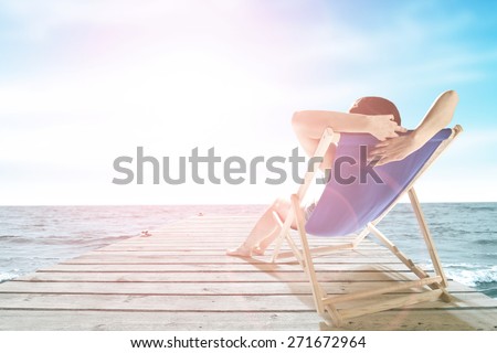 wooden gray pier and woman on chair