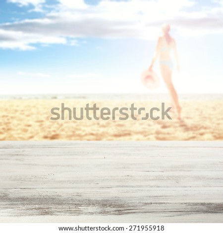 woman in bikini on hot summer sand of beach and white desk
