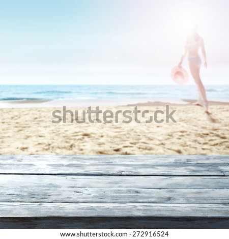 woman in bikini and blue desk of wood on beach