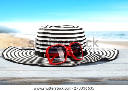 wooden blue desk and hat with red sun glasses