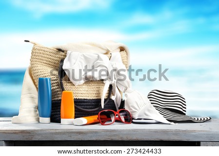 summer bag on blue desk and sea