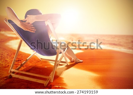 summer photo of beach and ocean and woman on chair