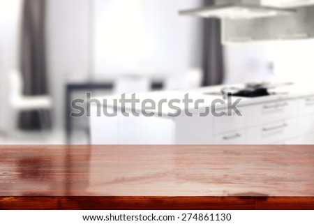 interior of white kitchen and red desk