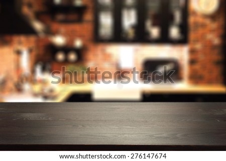 black desk space and blurred kitchen interior