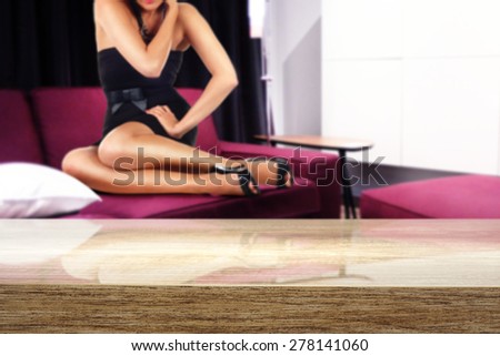 wooden top and woman on red sofa