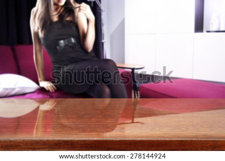 decoration of brown desk and woman on red sofa in home