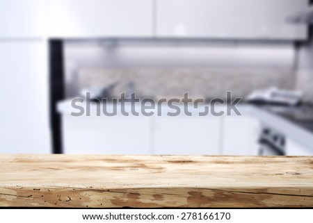 empty wooden desk and kitchen space