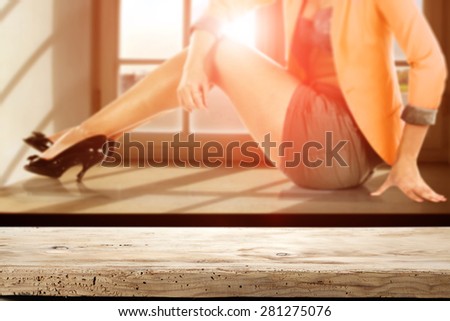 summer sunset with woman on window sill and wooden desk and free space for you