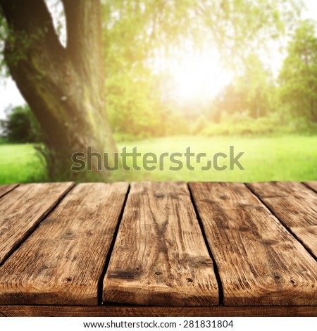 summer sunset in garden and worn brown table