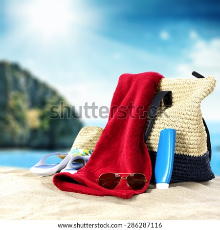 blue summer sky and sea of blue color with suntan oil bag and towel