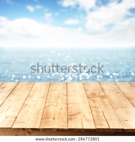 ocean sea and sky and deck of wood