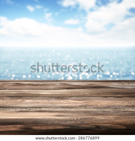 blurred blue background of sea and sky with desk top of brown color