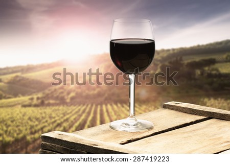 sunset with landscape of tuscany and red wine and wooden old top place
