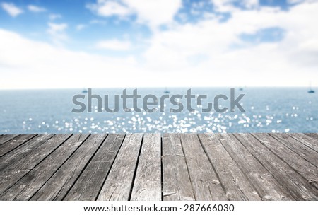 blurred background of sea and sky with gray pier