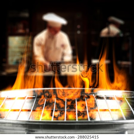 dark interior with cook and fire on grill and free space