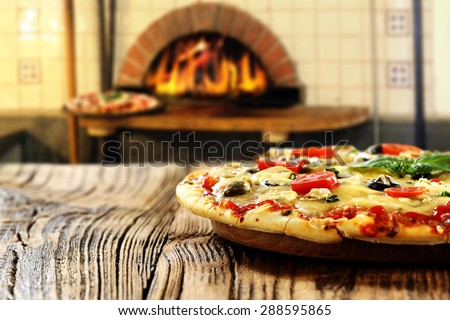 blurred background of fireplace and pizza on table