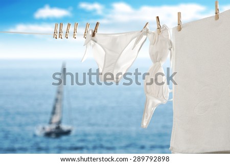 towel swimsuit and boat on sea